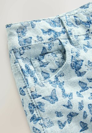 Light blue denim shorts with a butterfly print pattern, featuring a front pocket and silver button detail. Textured fabric with visible stitching.