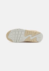 Outsole Nike tenisica s bijelom gumom, uzorkovana površina za prianjanje i bež akcenti, dizajnirana za prianjanje i izdržljivost.