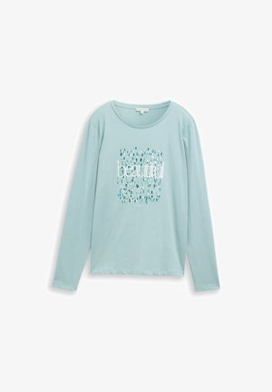 Svijetloplaka košulja dugih rukava od mekanog materijala, s natpisom "prelijepo" u bijeloj boji, uz uzorak tirkiznih i plavih kapi u pozadini.