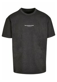 Sort bomulds T-shirt med rund halsudskæring. Har en hvid tekstprint med teksten "METAMORPHOSIS" foran. Korte ærmer, afslappet pasform.