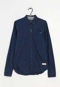 Tummansininen pitkähihainen puuvillapaita, jossa on napitettava etuosa, kaulus, yksi rintatasku ja kaareva helma. Sisältää tarralapun.