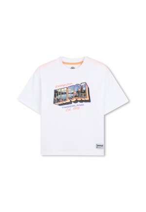 White cotton t-shirt featuring a colorful "Greetings from USA" graphic, short sleeves, round neck, and Timberland logo patch at the hem.