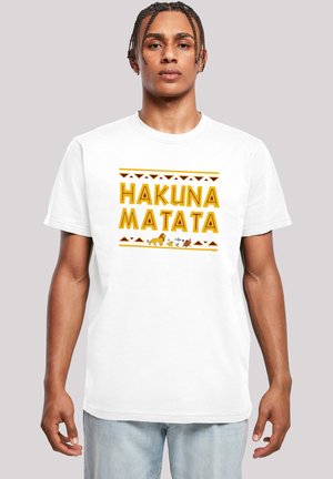 White cotton t-shirt featuring "HAKUNA MATATA" in yellow lettering, accented with tribal patterns and animal graphics at the bottom.