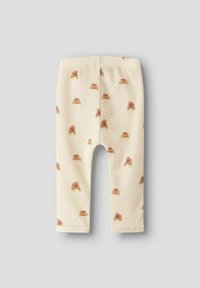 Bleekgele, geribbelde leggings met een herhaald bruin croissantpatroon. Heeft een zachte tailleband en een rechte, enkel-lange snit.