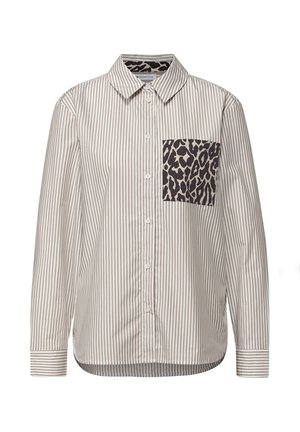 Skjorta med knappar i randigt beige och brunt tyg, med en leopardmönstrad ficka på vänster sida. Långärmad med detalj vid manschetten.