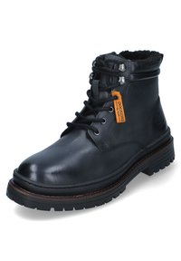 Bota de tobillo de cuero negro con diseño de cordones, cuello acolchado, suela de goma y costuras decorativas; cuenta con una etiqueta de marca en naranja.