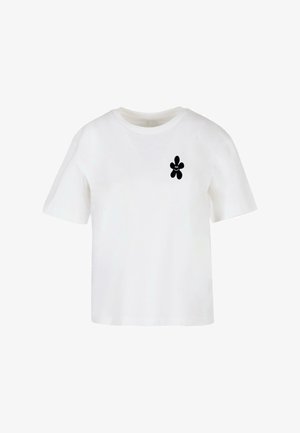 Witte T-shirt met korte mouwen van katoen, met een zwart bloemvormig ontwerp op de linker borst. Ronde hals en ontspannen pasvorm.