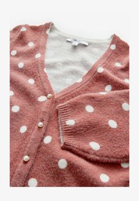 Atlasīts, brown spot