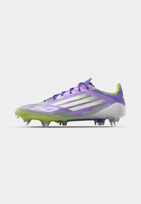 Purple and green soccer cleat with a sleek design, featuring a textured upper, six studs on the outsole, and prominent three-stripe branding.