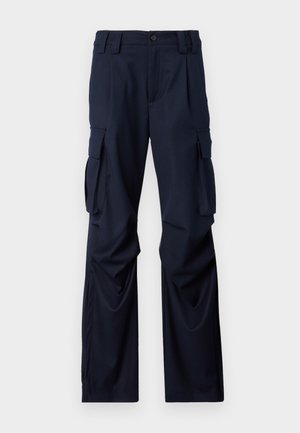 Navy cargo pants made of fabric with a smooth texture, featuring two side pockets and a straight-leg design. Button closure at the waistband.