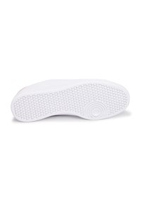 Suela de zapatilla de goma blanca con un patrón texturizado de pequeños círculos y un acento circular. Superficie lisa, diseñada para mejorar el agarre.