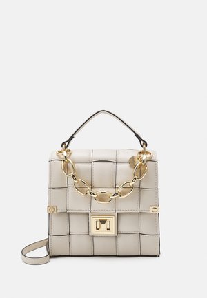 Beige leather handbag with a woven design, gold chain accent, and a flap closure featuring a rectangular clasp. Includes a black handle.