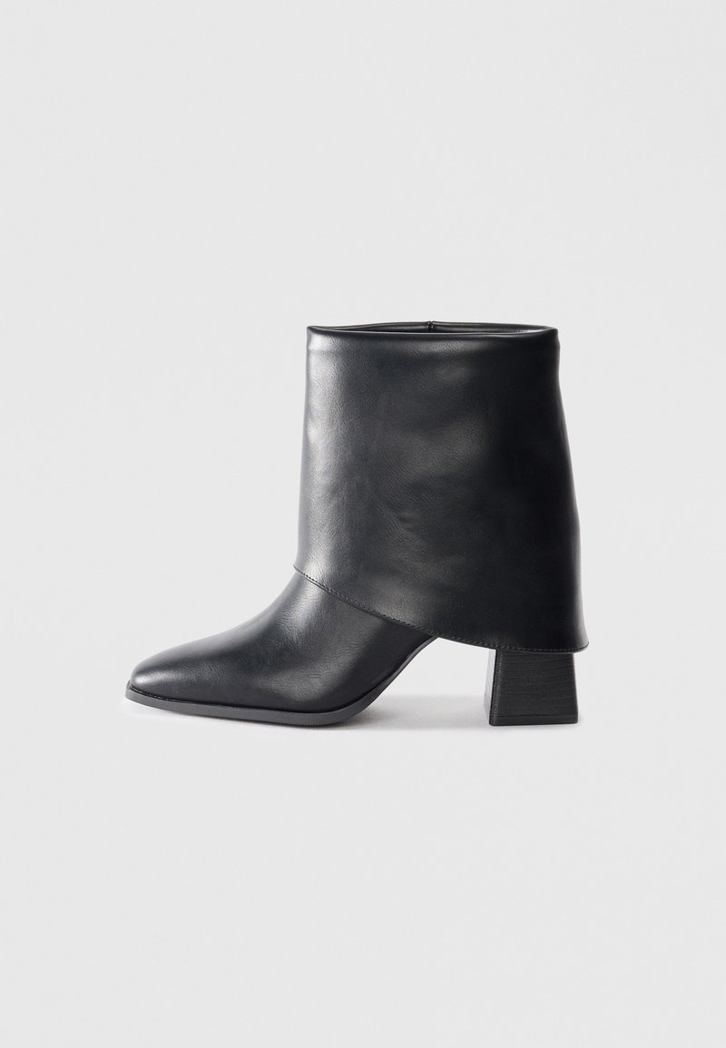 Black leather ankle boot with a pointed toe, smooth texture, and a structured block heel. Features a high, folded cuff design.
