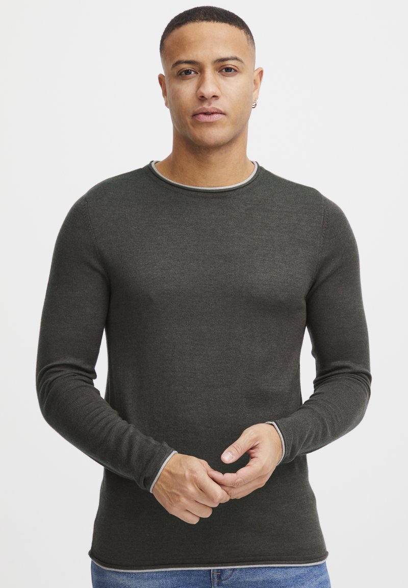 Dark green long-sleeve shirt with a round neckline, featuring contrasting light gray trim at the collar and cuffs, made of a smooth fabric.