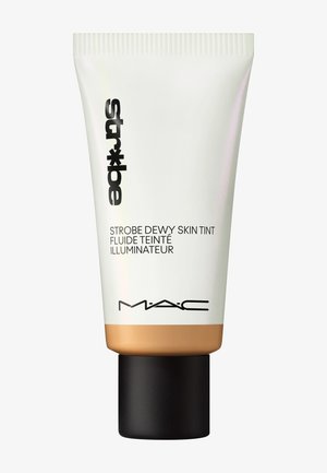 White plastic tube with a gold base, featuring black text. Label reads "Strobe Dewy Skin Tint." Textured cap is black and round.