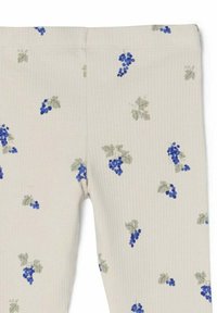 Kangas leggingsi vaaleanbeige värissä, joissa on ribbikuvio ja sinisen sekä vihreän sävyinen satunnaisesti levitetty viinipuun kuvio.