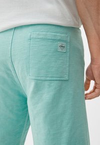 s.Oliver Pantaloni sportivi - helles türkis