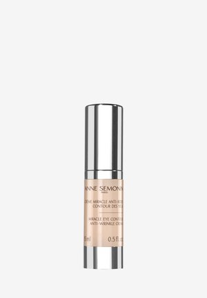 Crème pour les yeux dans un flacon argenté et beige élégant, avec un capuchon lisse et étiqueté avec les détails du produit. Contenu : 15 ml (0,5 fl. oz.).