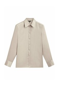 Chemise beige à manches longues, boutonnée, avec col pointu et larges poignets, posée à plat sur un fond blanc.