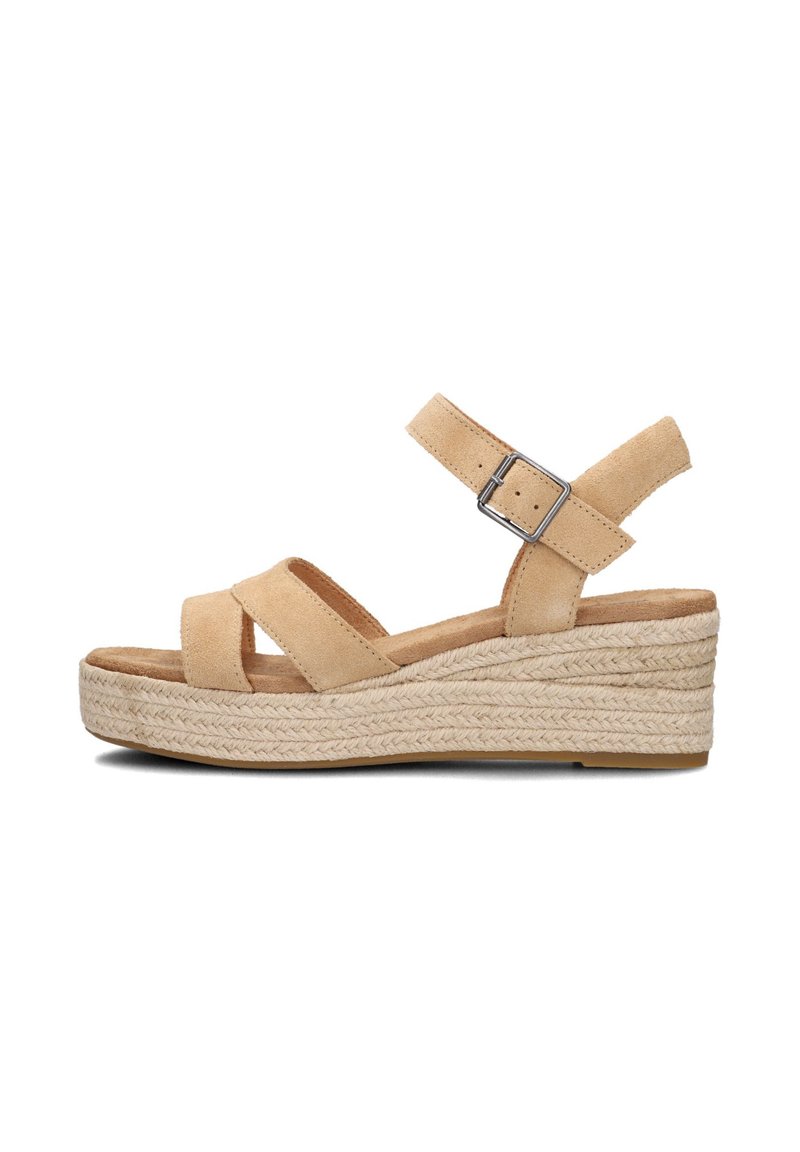 Beige suede wedge sandals with multiple crisscross straps and adjustable ankle buckle. Jute-wrapped midsole, flat rubber outsole.