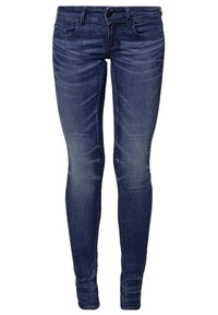 Blå denim skinny jeans med medelhög midja, som har fem fickor, subtila slitningar och en åtsittande silhuett.