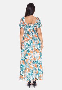 Maxi kjole med et blomstermønster i teal og orange, med firkantet halsudskæring, puffede ærmer, smocket ryg og et svævende stof.