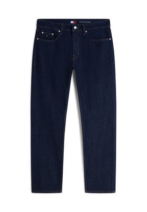 Jeans slim dritti di colore blu scuro con cinque tasche e chiusura con bottone, caratterizzati da cuciture sottili arancioni e un piccolo logo a bandiera sulla tasca anteriore.