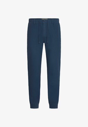 Marinblå joggerbyxor i lätt tyg, med elastisk midja och dragsko, samt elastiska muddarna vid anklarna.