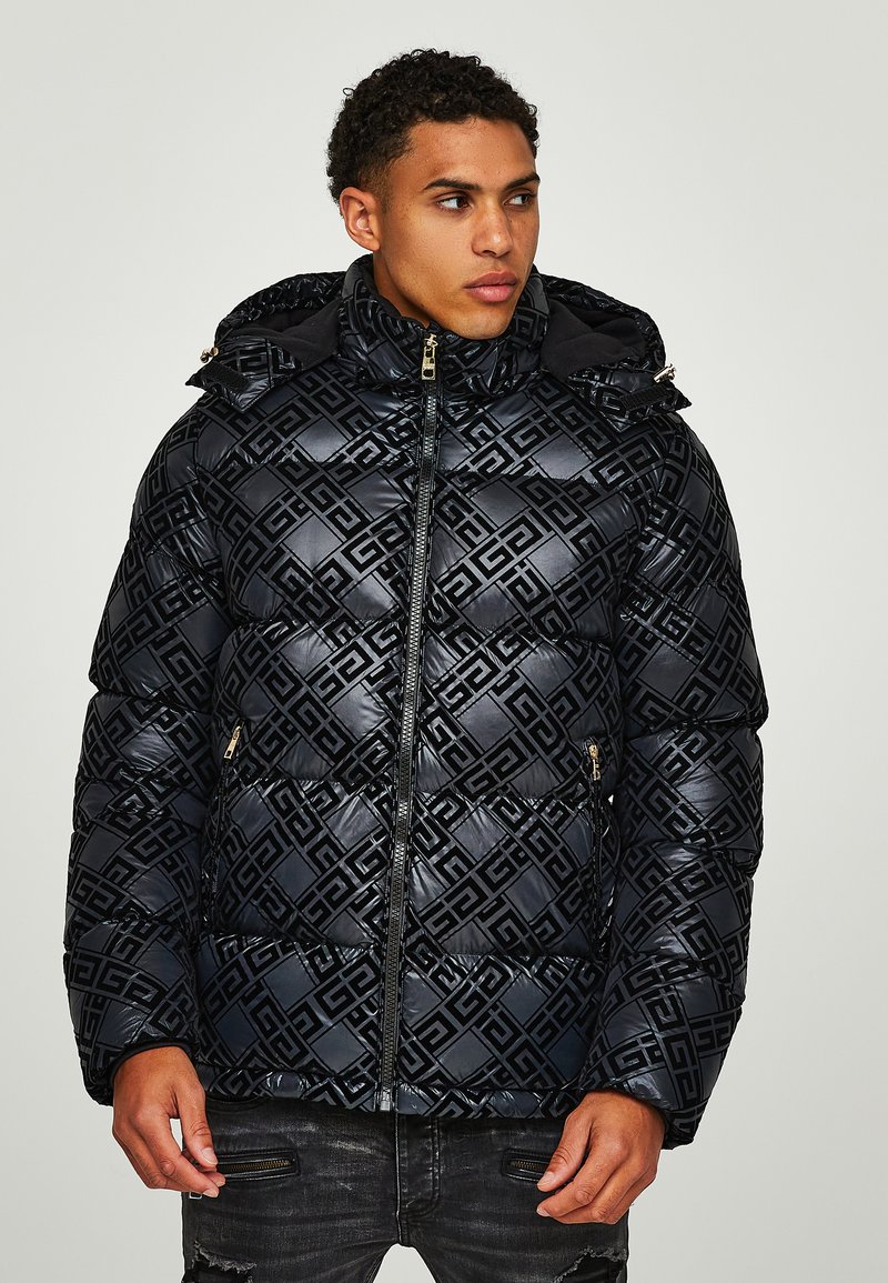 Padded black jacket featuring a geometric embossed pattern, zippered front, and a hood. Textured fabric with a glossy finish and gold hardware accents.