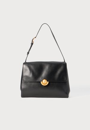 Black leather handbag with a structured shape, flat top, and a golden circular clasp. Features a single shoulder strap for carrying.