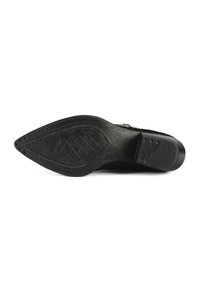 Black shoe sole with a pointed shape, textured rubber, and stitched detailing. Features a diamond pattern and subtle brand logo.