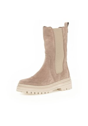 Suede beige ankle boot with elastic side panels, rounded toe, chunky sole, and textured detailing on the upper and sole.