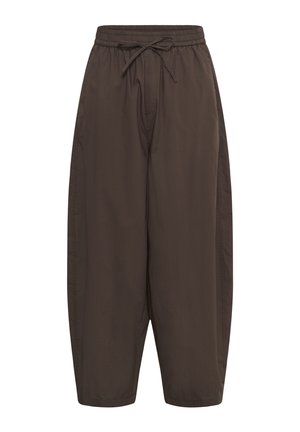 Brown loose-fit trousers with elastic waistband and adjustable drawstring, straight legs, and side pockets.