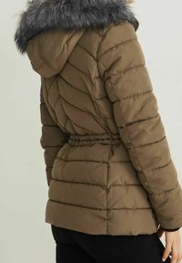 Brown puffer jacket with a detachable gray fur collar, quilted texture, cinched waist, and long sleeves.