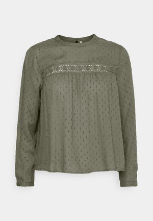 Blusa verde oliva con maniche lunghe, scollatura rotonda e dettagli in pizzo sul busto. Tessuto testurizzato con piccoli punti ricamati in tutto il capo.