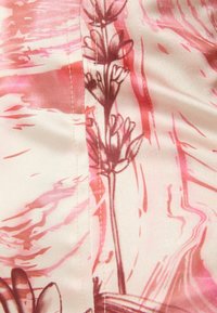 Silk fabric featuring a floral pattern in pink hues, with brown outlines and wavy abstract designs in the background. Visible stitching detail.