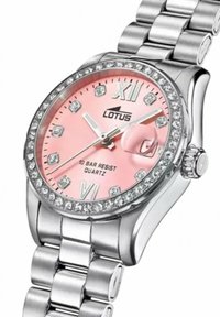 Montre en quartz Lotus avec un cadran rose, un boîtier en métal argenté et un bracelet. Présente des accents en cristal sur la lunette et les index.