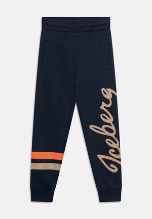 Donkerblauwe sweatpants met beige "Iceberg"-script op het rechterbeen en oranje, marineblauwe, beige strepen op het linkeronderbeen, voorzien van zijzakken en elastische boorden.