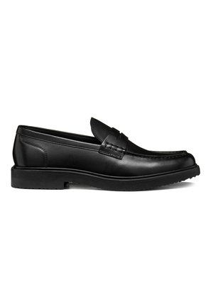 Black leather loafer with a low heel, moc toe stitching, and a strap detail on the upper, shown from the side on a white background.