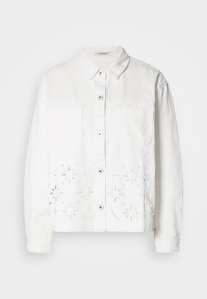 White denim jacket featuring a button-up front, two chest pockets, and floral cut-out embroidery along the bottom hem.