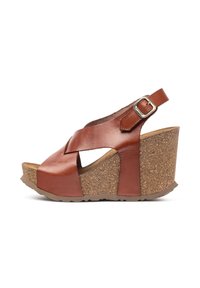Brown leather wedge sandals with a cork platform, featuring a crisscross strap design and an adjustable buckle on the ankle strap.