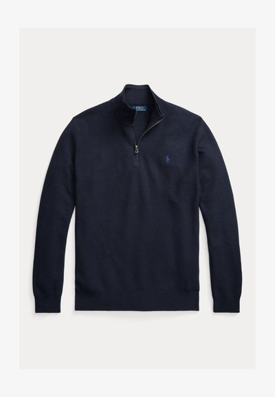 Pulover cu fermoar de culoare albastru marin, textură tricotată, cu manșete și tiv cu margini ondulate, având un mic logo pe partea stângă a pieptului, cu guler înalt și fermoar.