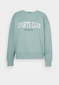 Felpa di un leggero color turchese con scollatura rotonda e spalle scese. Presenta la scritta "SPORTS CLUB" stampata in bianco e "BJÖRN BORG" sotto in nero.