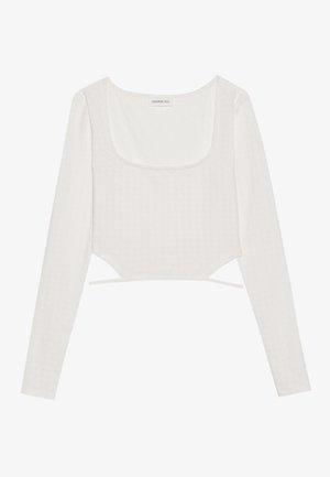 Biała długosleeve crop top wykonana z teksturowanej tkaniny, z kwadratowym dekoltem i wiązaniami po bokach, z subtelnymi detalami wzorniczymi.