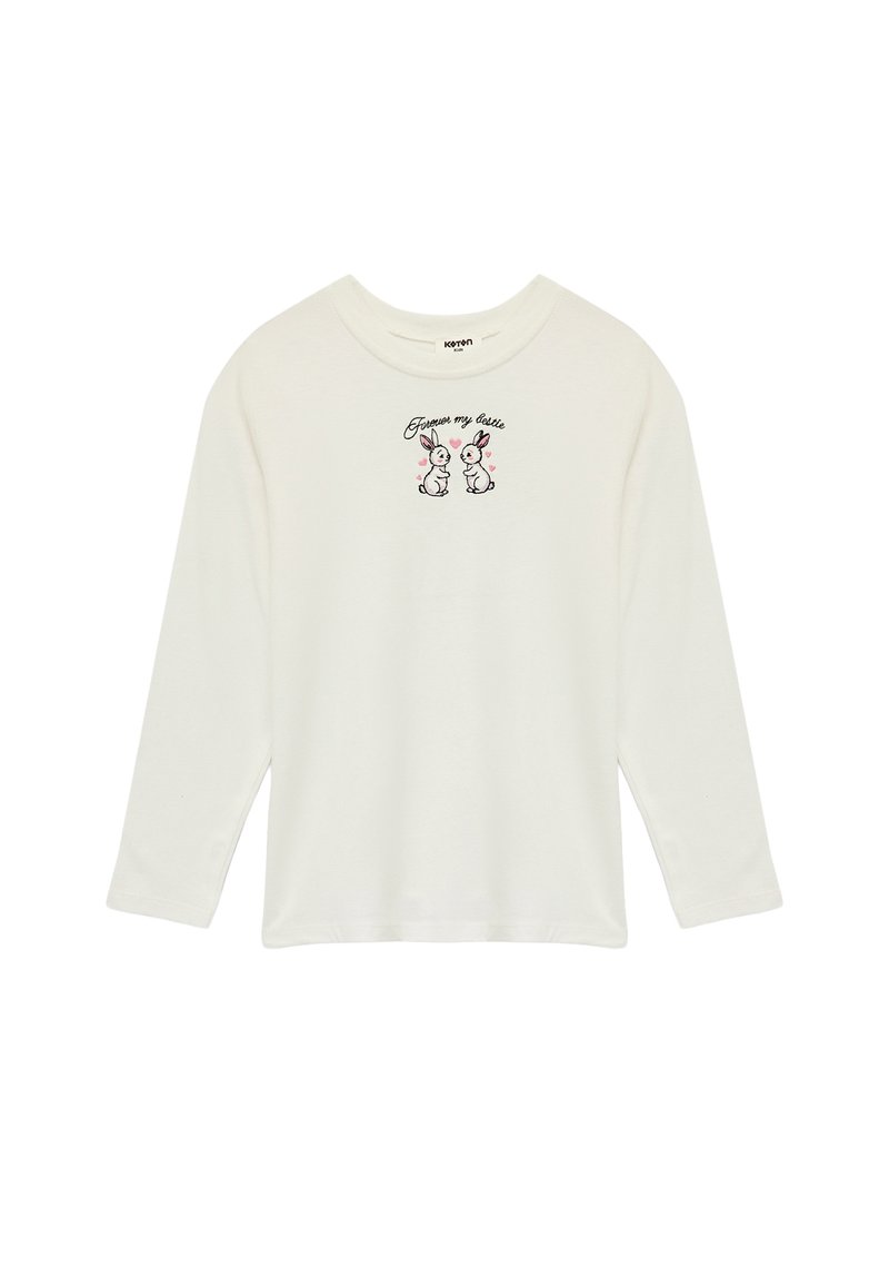 Langærmet, krämfarvet t-shirt lavet af blødt stof med en frontbrodering af to kaniner og teksten "Forgive my cutie."