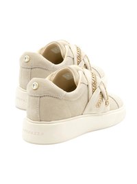 Sneakers in suede beige con una texture liscia, caratterizzati da accenti in catena d'oro intrecciati e una suola in gomma bianca. Dettaglio del logo discreto sul tallone.