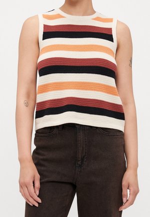 Mouwloos gebreid topje met horizontale strepen in creme, zwart, roest en oranje, gedragen met een hooggetailleerde donkerbruine broek.