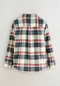 Ruudullinen nappipaita, jossa on sekoitus laivaston sinistä, punaista ja kermaista väriä, pitkät hihat ja pyöristetty helma. Tehty pehmeästä kankaasta.