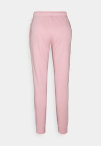 Light pink sweatpants with a soft texture, elastic waistband, and tapered ankles. Feature side pockets and a smooth, minimal design.
