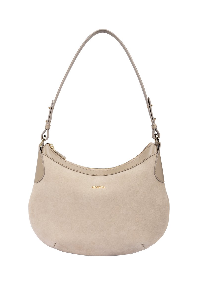 Beige suede handbag with a curved shape and a smooth leather top panel. Features a single shoulder strap and a gold logo accent.
